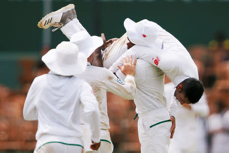 Cricket - Sri Lanka v South Africa - Second Test Match - Colombo, Sri Lanka - July 20, 2018 - South Africa's Keshav Maharaj celebrates with his teammates after taking the wicket of Sri Lanka's Danushka Gunathilaka. REUTERS/Dinuka Liyanawatte