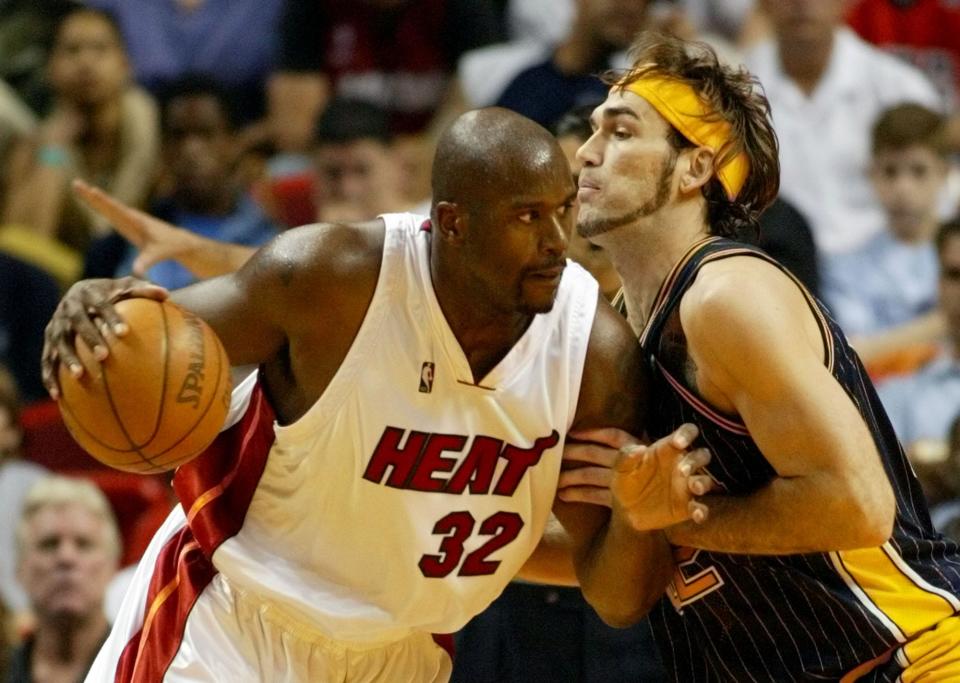 Miami Heat center Shaquille O'Neal (32) attempts to drive past Indiana Pacers center Scot Pollard, April 17, 2005 in Miami.