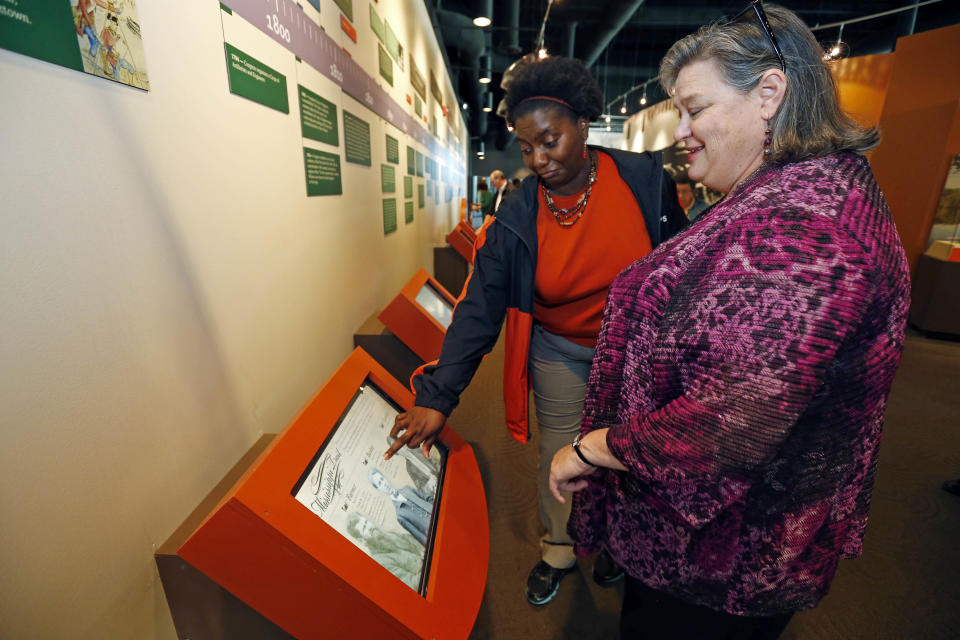 In this Dec. 18, 2012 photograph, Mississippi Association of Educators Teri Rounsaville, right, and Jerri McGee engage the interactive kiosk at the Lower Mississippi River Museum in Vicksburg, Miss. The kiosk explores the lives of three residents of Vicksburg in the 1800's, providing visitors with a extensive look at life surrounding the Mississippi River. (AP Photo/Rogelio V. Solis)