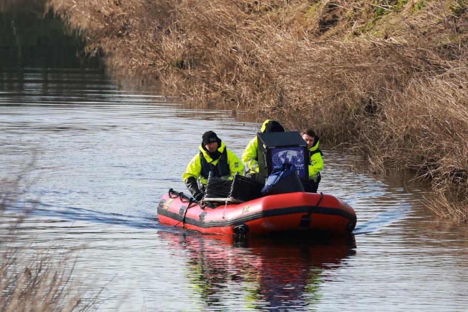 Members of the Specialist Group International pictured on February 6, searchiong the River Wyre in Lancashire for missing Nicola Bulley (REUTERS)