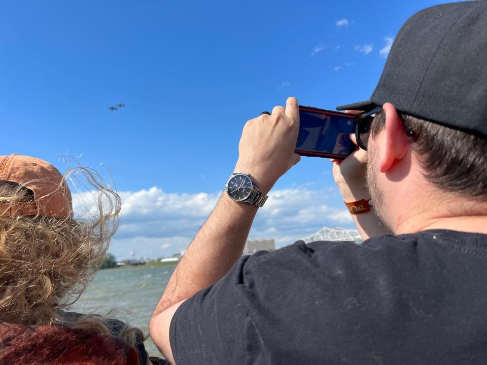 Gavin Pigman, of Charlestown, Indiana, takes video of the planes at Thunder Over Louisville airshow on Saturday, April 22, 2023.