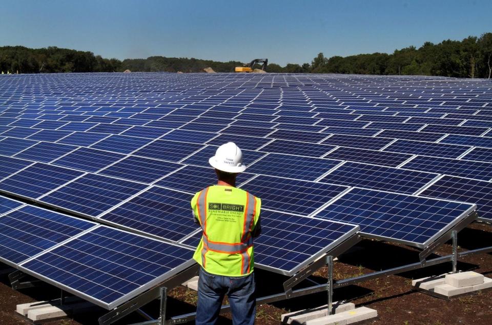 A field of solar panels installed at a capped landfill in East Providence.