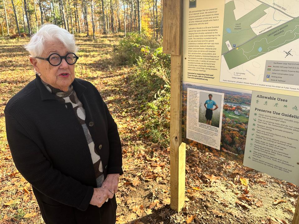 The Fuller family has donated 35 acres to the York Land Trust in honor of the late Lafcadio Cortesi, an accomplished conservationist. His aunt Martha Fuller Clark, a retired state senator from Portsmouth, stands by a sign marking the land and commemorating Cortesi.