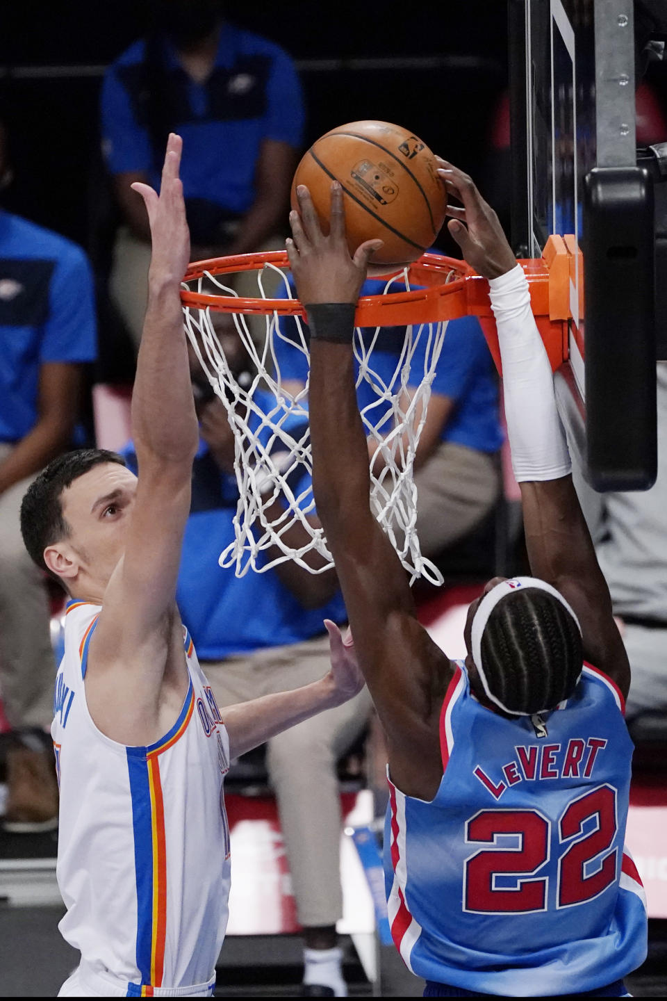 Oklahoma City Thunder forward Aleksej Pokusevski (17) defends Brooklyn Nets guard Caris LeVert (22) as LeVert scores during the second half of an NBA basketball game Sunday, Jan. 10, 2021, in New York. (AP Photo/Kathy Willens)