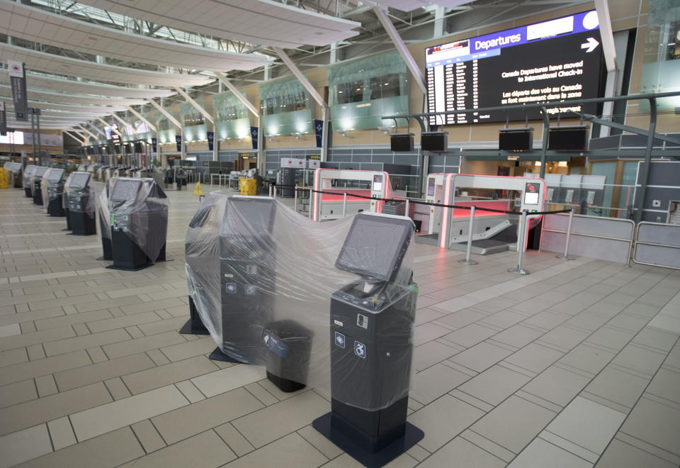 Check in Kiosks are covered in plastic at the domestic check in, at Vancouver International Airport, Tuesday, June 9, 2020. Airlines in Canada and around the world are suffering financially due to the lack of travel and travel bans due to COVID-19. (Jonathan Hayward/The Canadian Press via AP)