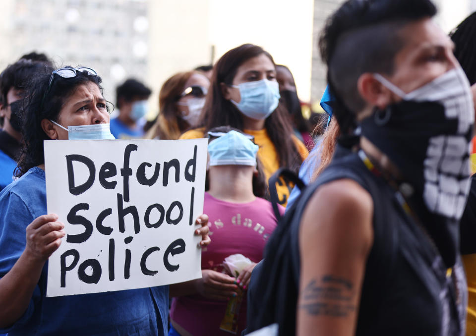 Image: People protest outside the Unified School District headquarters calling on the board of education to 'fully defund' Los  Angeles school police on June 22, 2021. (Mario Tama / Getty Images)