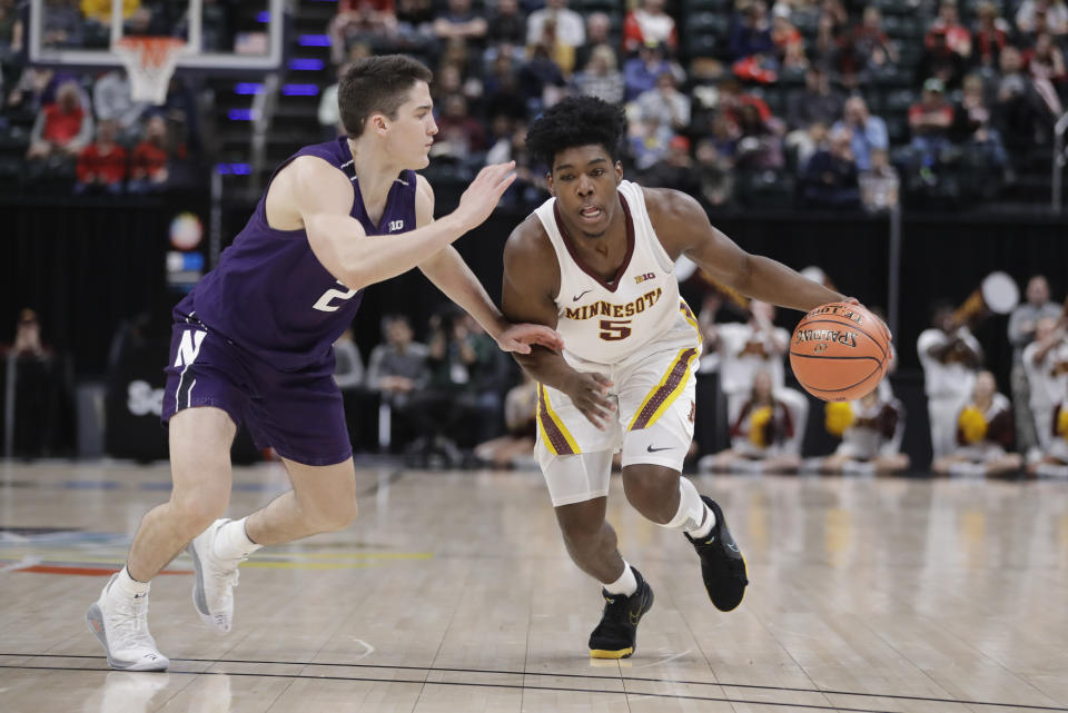 Minnesota's Marcus Carr (5) goes to the basket against Northwestern's Ryan Greer (2) during the first half of an NCAA college basketball game at the Big Ten Conference tournament, Wednesday, March 11, 2020, in Indianapolis. (AP Photo/Darron Cummings)