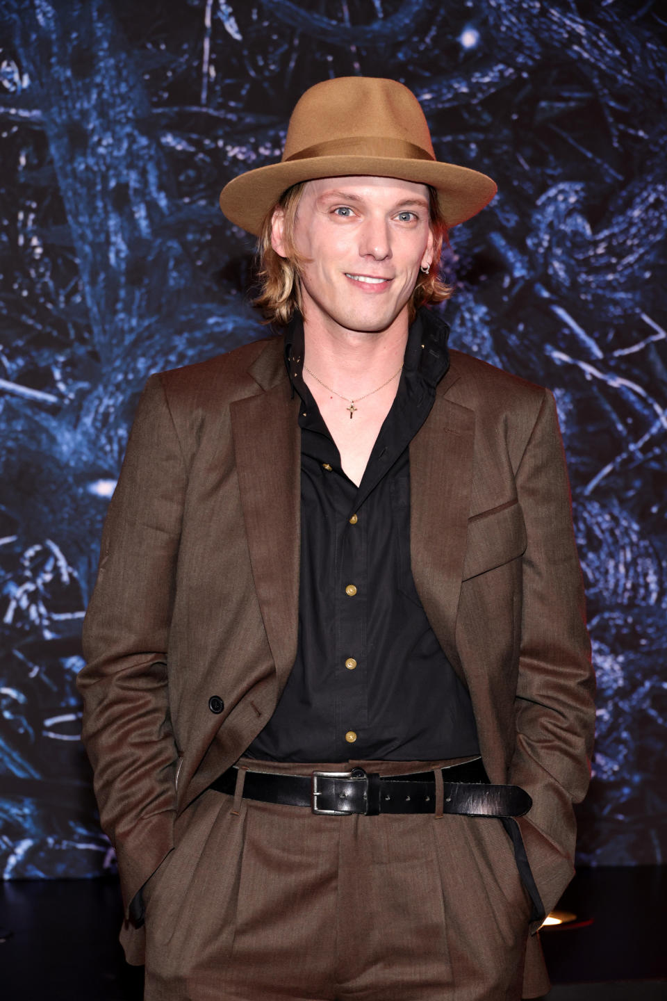 Jamie Campbell Bower in a suit at an event