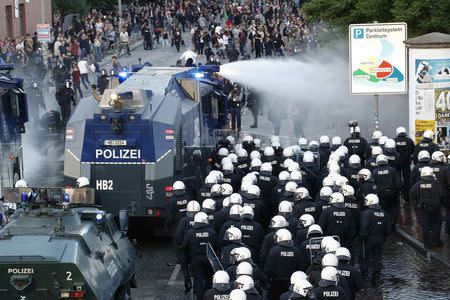 German riot police use water cannons against protesters during the demonstrations during the G20 summit in Hamburg, Germany, July 6, 2017. REUTERS/Fabrizio Bensch