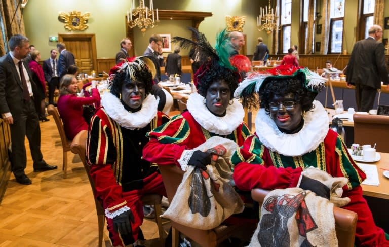 (From L) Dutch right wing PVV State members Ton van Kesteren, Matthijs Jansen and Dennis Ram dressed as Black Pete, the jolly sidekick of the Dutch Saint Nicholas, seen in Groningen, in November 2014