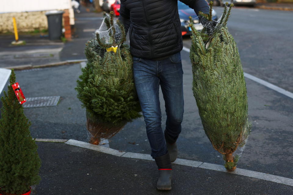 Workers at Mistletoe and Pine set up a Christmas tree stand, amid the coronavirus disease (COVID-19) outbreak in the Dulwich area of London, Britain, November 22, 2020. REUTERS/Simon Dawson