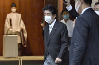 Former Japanese Prime Minister Shinzo Abe, center, visits Yasukuni shrine in Tokyo, Japan, on Aug. 15, 2021. Sanae Takaichi and Seiko Noda are the first women in 13 years seeking the leadership of the ruling Liberal Democratic Party in an election Wednesday, Sept. 29. Takaichi is seen by some as a fast-rising candidate, with the crucial backing of former leader Abe, whose arch-conservative vision she supports. (Ryosuke Ozawa/Kyodo News via AP)