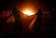 <p>Participants surround a burning art installation as approximately 70,000 people from all over the world gathered for the annual Burning Man arts and music festival in the Black Rock Desert of Nevada, Sept. 1, 2017. (Photo: Jim Urquhart/Reuters) </p>