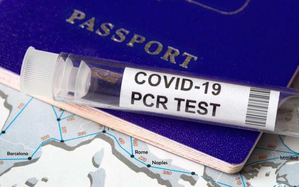 A tube for a coronavirus PCR test with a passport - iStockphoto