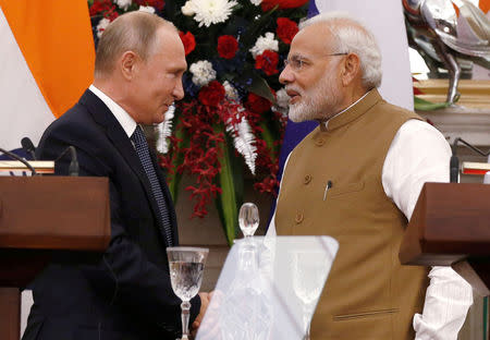 Russian President Vladimir Putin and India's Prime Minister Narendra Modi shake hands after delivering a joint statement after their delegation level talks at Hyderabad House in New Delhi, October 5, 2018. REUTERS/Adnan Abidi