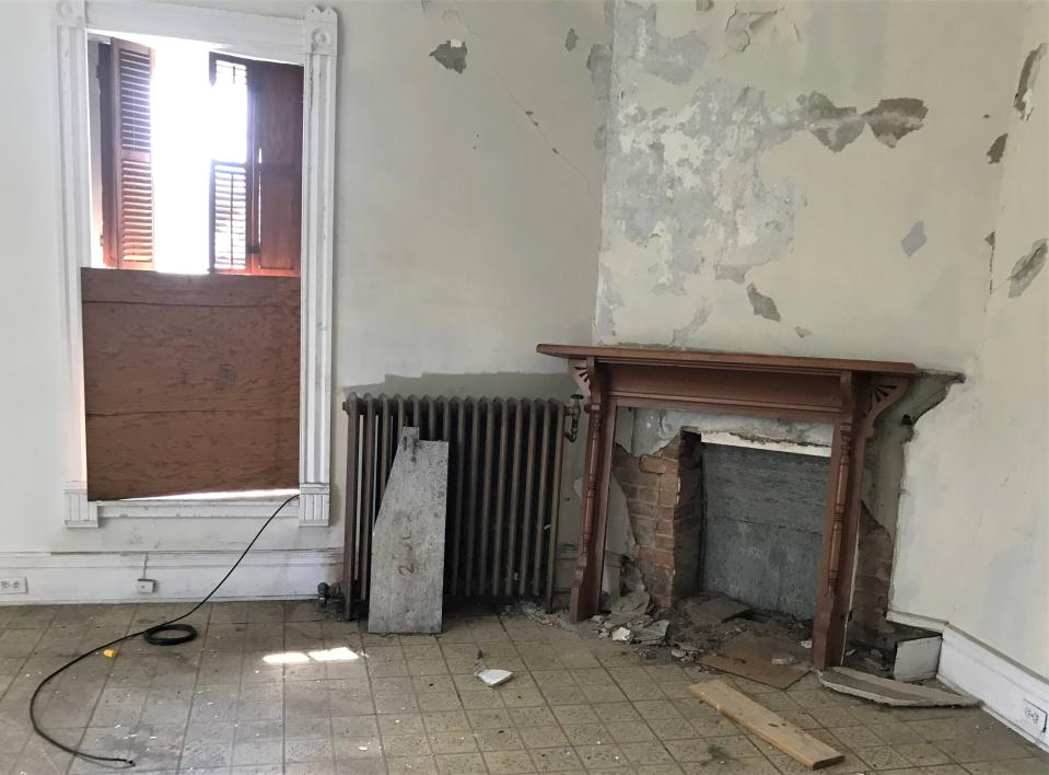 A fireplace sits in the corner of a bedroom of the vacant Strawberry Mansion on William Street in Elmira.