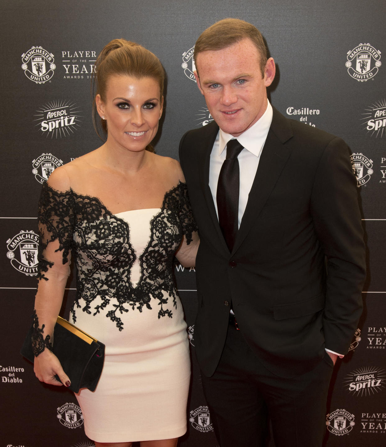 Manchester United's English striker Wayne Rooney and his wife Coleen pose for pictures on the red carpet as they arrive to attend the 'Manchester United Player of the Year Awards' at Old Trafford stadium in Manchester, northern England, on May 19, 2015. AFP PHOTO / OLI SCARFF (Photo by Oli SCARFF / AFP) (Photo by OLI SCARFF/AFP via Getty Images)