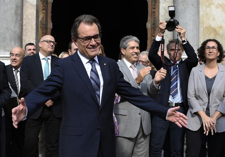 Catalonia president Artur Mas greets supporters after signing the regional law to vote on independence on September 27, 2014 in Barcelona