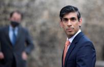 Britain's Chancellor of the Exchequer Rishi Sunak looks on as he leaves following an outside broadcast interview, in London