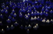 Performers dance in the rain during the 2014 Nanjing Youth Olympic Games opening ceremony, in Nanjing, Jiangsu province, August 16, 2014. REUTERS/Aly Song