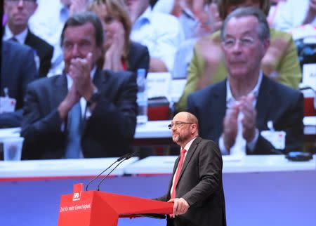 German Chancellor candidate Martin Schulz of the Social Democratic party (SPD) delivers his speech as former German Chancellor Gerhard Schroeder and former SPD leader Franz Muentefering are seen on a screen at the party convention in Dortmund, Germany, June 25, 2017. REUTERS/Wolfgang Rattay