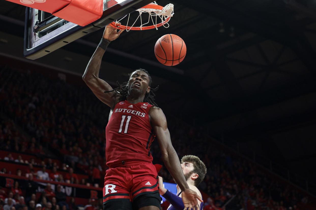 Rutgers Scarlet Knights center Clifford Omoruyi (11) dunks the ball in front of Northwestern Wildcats forward Gus Hurlburt (54) during the second half at Jersey Mike's Arena.