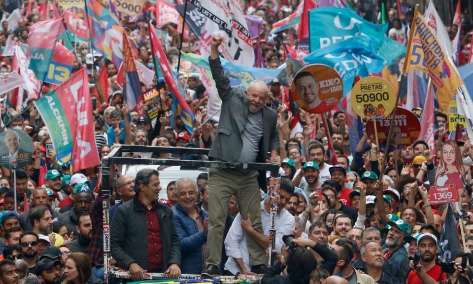 Lula greets supporters during a campaign rally