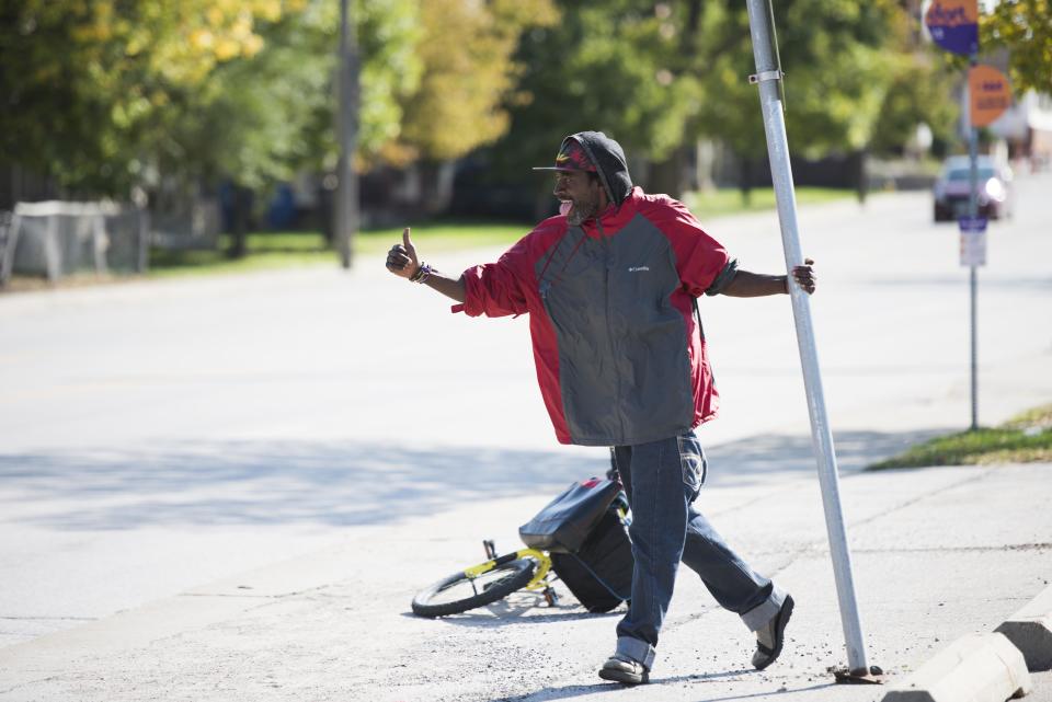 Ajamu El Amin (aka AJ The Dancer) dances on the sidewalk.