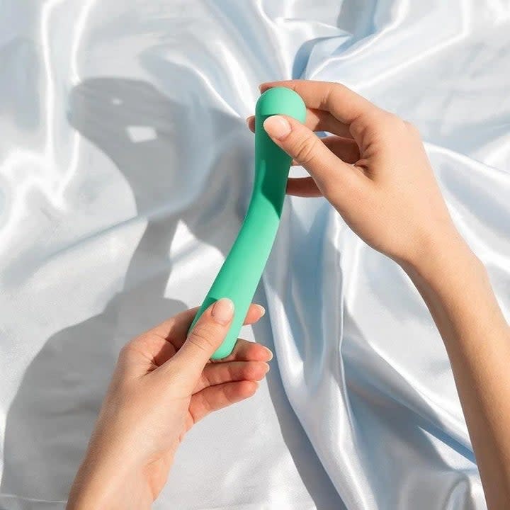 Hands holding green flexible vibrator