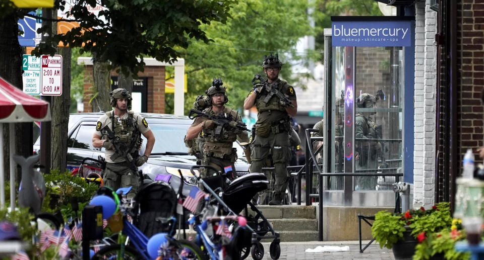 Armed men search the street 