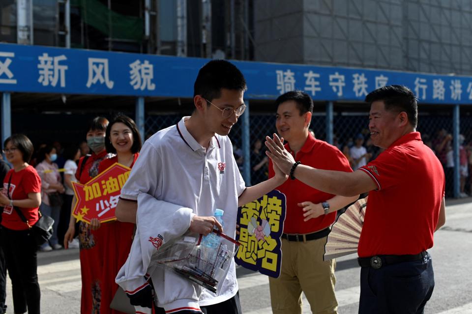 Students enter a school on the first day of China's national college entrance examination, known as the gaokao, in Beijing on June 7, 2023.