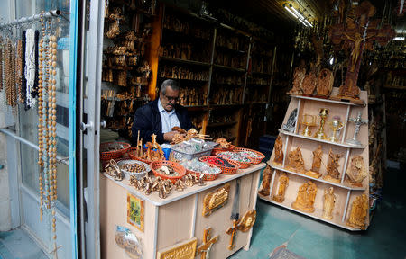 A vendor sells Christmas souvenirs in a shop in Bethlehem in the occupied West Bank, December 10, 2018. REUTERS/Raneen Sawafta