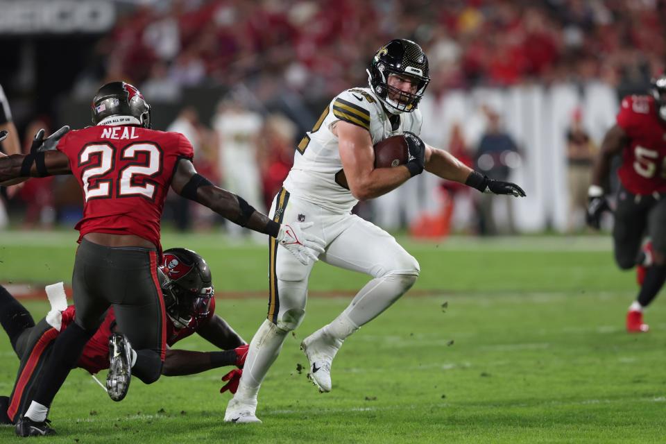 New Orleans Saints tight end Adam Trautman carries past Tampa Bay Buccaneers safety Keanu Neal (22) in the second half of an NFL football game in Tampa, Fla., Monday, Dec. 5, 2022. (AP Photo/Mark LoMoglio)