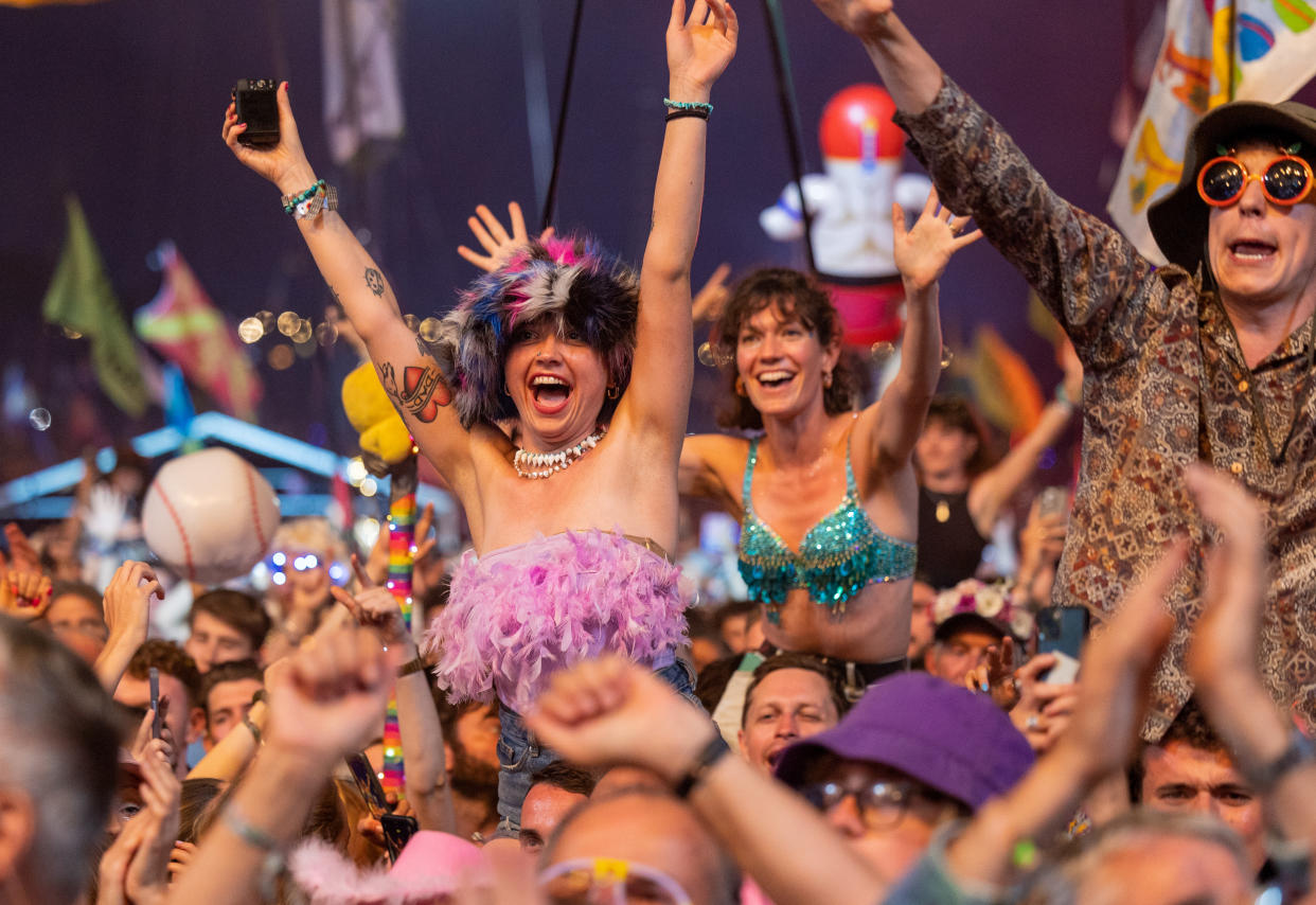 : The crowd in front of the main Pyramid Stage dance and cheer as they watch Elton John perform at Glastonbury 2023