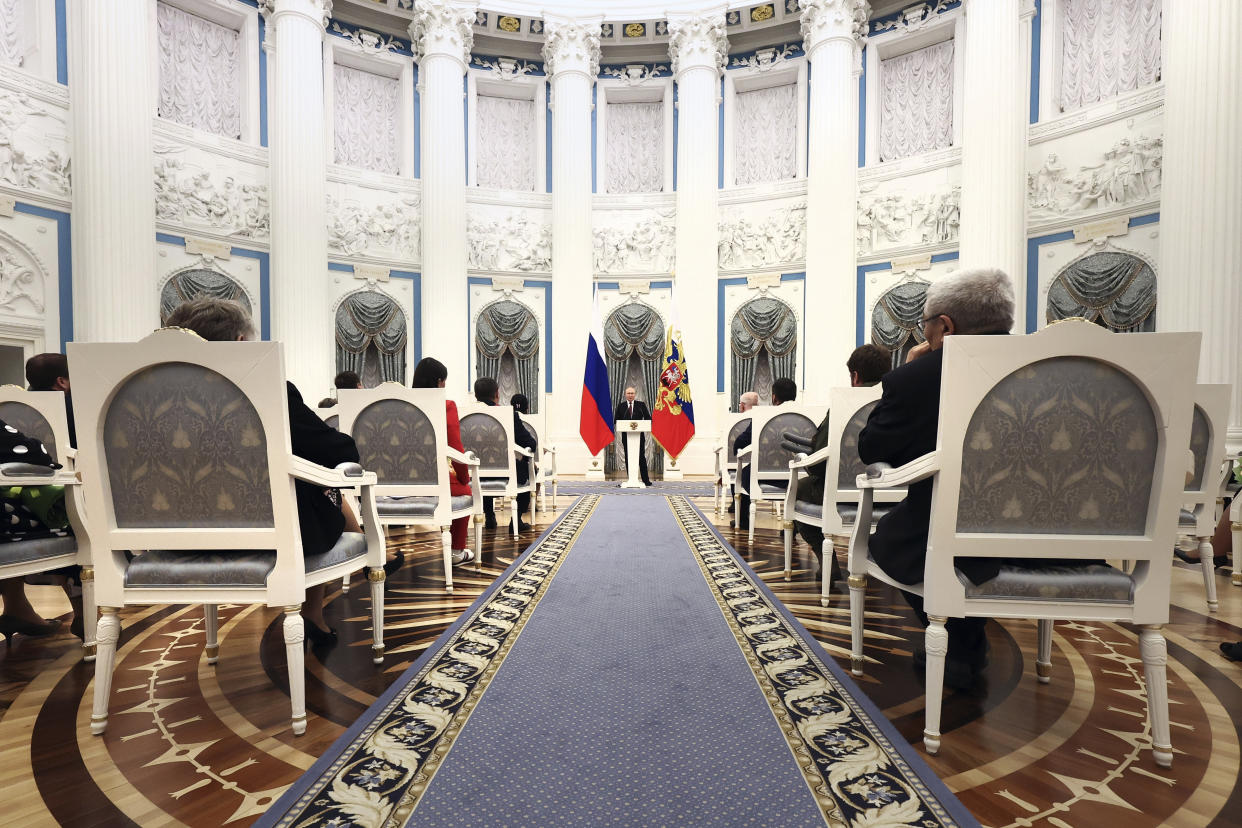 Russian President Vladimir Putin, centre, speaks during an awarding ceremony at the Kremlin's St. Catherine Hall in Moscow, Russia, Tuesday, Dec. 20, 2022. (Valeriy Sharifulin, Sputnik, Kremlin Pool Photo via AP)