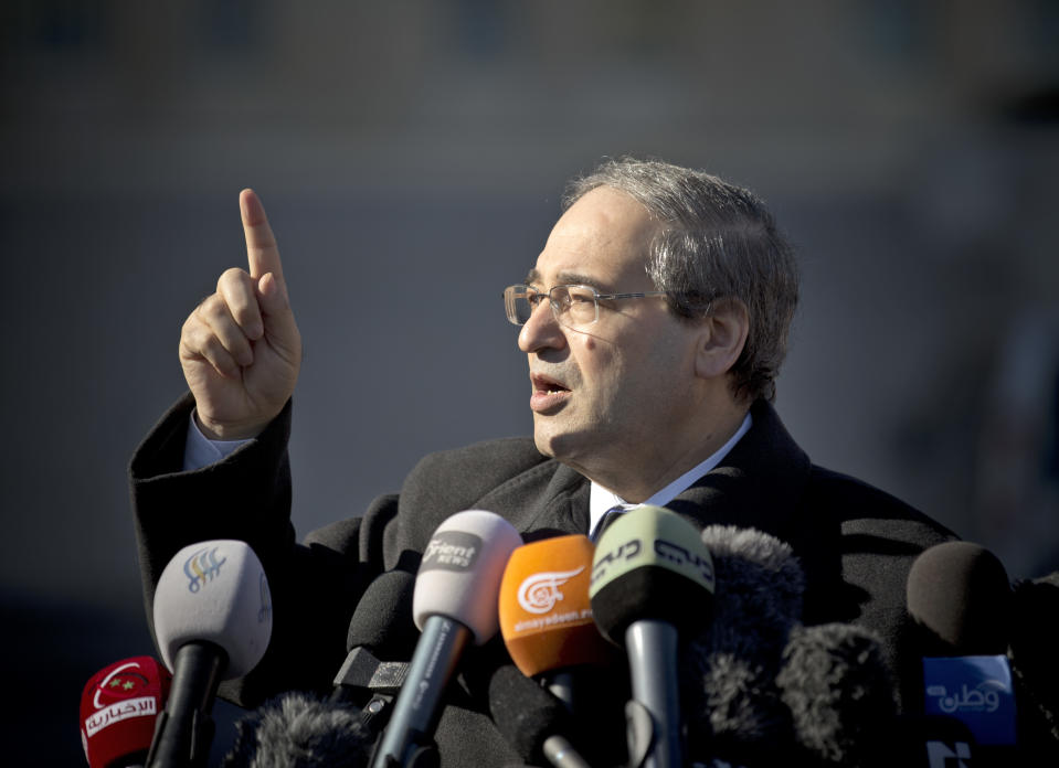 Syrian Deputy Foreign Minister Faisal Mekdad gestures as he talks to journalists after a meeting with the Syrian opposition at the United Nations headquarters in Geneva, Switzerland, Switzerland, Tuesday, Feb 11, 2014. A second round of peace talks between the Syrian government and the opposition bogged down quickly Tuesday in recriminations about who was responsible for escalating violence that has killed hundreds in the past few days and disrupted food aid for trapped civilians. (AP Photo/Anja Niedringhaus)