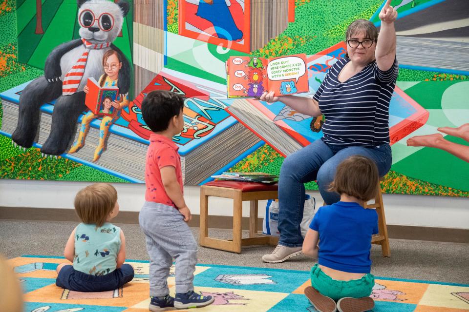 Library assistant Amy Taylor reads a book during preschool storytime at the Chavez Central Library in downtown Stockton on Thursday, Apr. 27, 2023. The library has been awarded a $10 million grant from the California State Library.