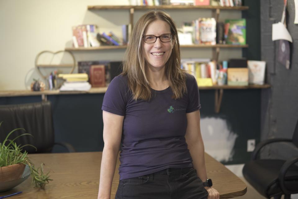 Katie Donegan smiling sat on table. (Supplied)                               