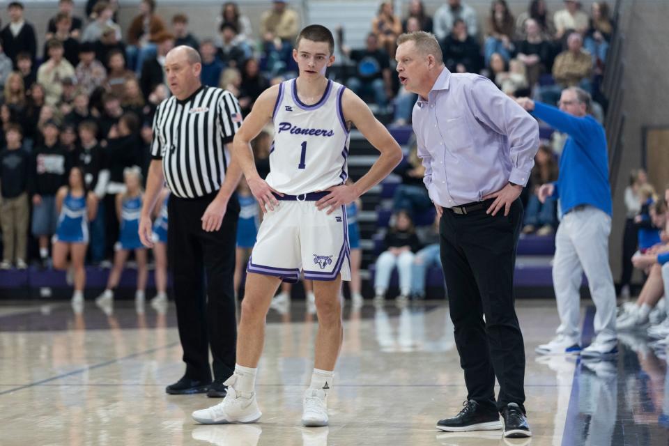 Cooper Lewis, left, listens to his father, coach Quincy Lewis, during a game against Pleasant Grove at Lehi High School in Lehi on Friday, Jan. 26, 2024. Lehi won 77-61. | Marielle Scott, Deseret News