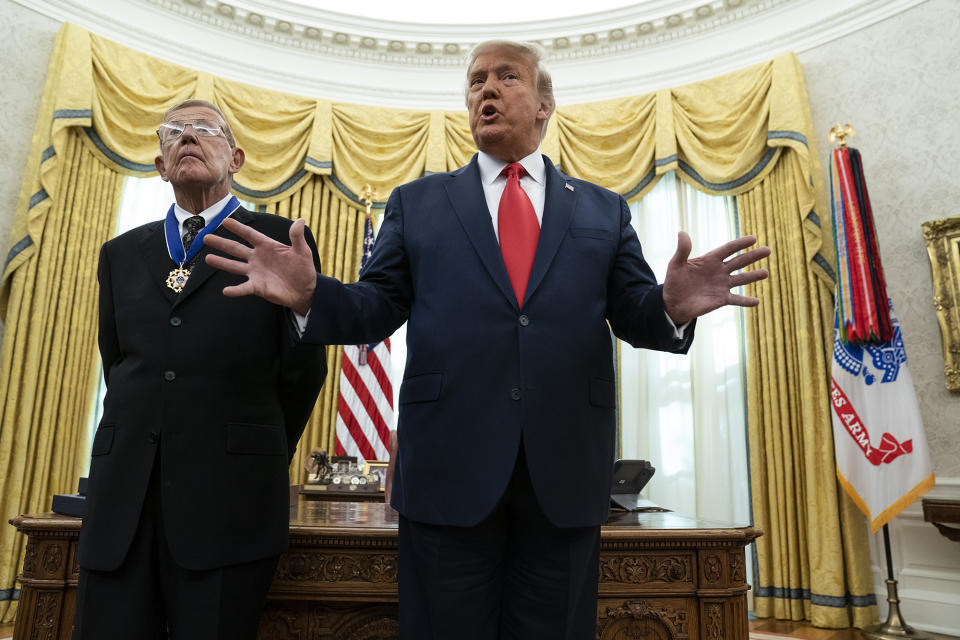 President Trump speaks during a ceremony to present the Presidential Medal of Freedom to former football coach Lou Holtz, in the Oval Office of the White House, Dec. 3, 2020, in Washington.