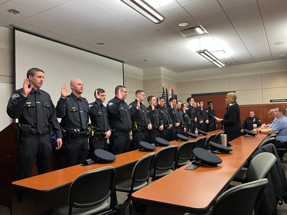 South Bend clerk Dawn Jones swears in a group of 16 South Bend police officers in the police department headquarters on Wednesday, March 15, 2023.