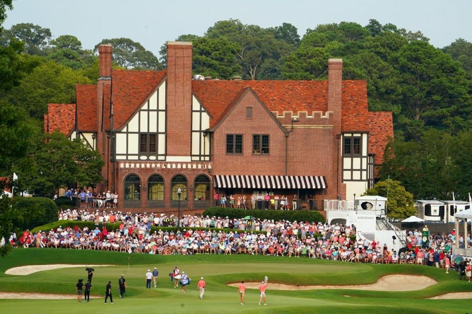 Keegan Bradley and Collin Morikawa walk up onto the 18th green during the final round of the TOUR Championship golf tournament at East Lake Golf Club. Mandatory Credit: John David Mercer-USA TODAY Sports