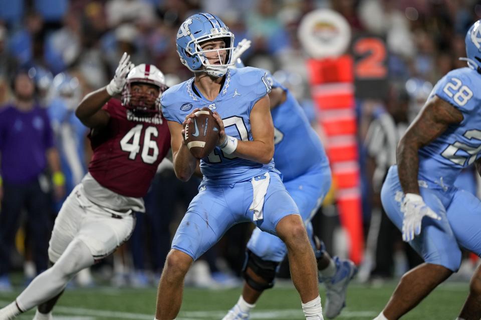 Sep 2, 2023; Charlotte, North Carolina, USA; North Carolina Tar Heels quarterback Drake Maye (10) drops back to pass pressured by South Carolina Gamecocks defensive end Bryan Thomas Jr. (46) during the second half at Bank of America Stadium. Mandatory Credit: Jim Dedmon-USA TODAY Sports