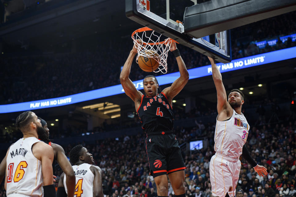 Toronto Raptors forward Scottie Barnes (4) dunks the ball while Miami Heat guard Max Strus (31) defends during the first half of an NBA basketball game Tuesday, March 28, 2023, in Toronto. (Christopher Katsarov/The Canadian Press via AP)