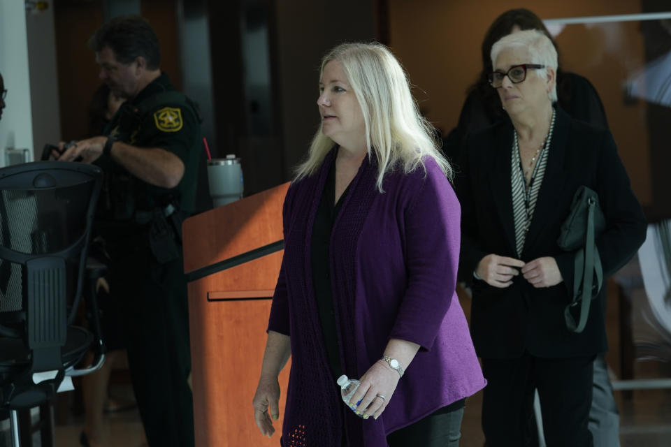 Bree Wikander walks to the courtroom at the Broward County Courthouse for the sentencing hearing of Florida school shooter Nikolas Cruz, Tuesday, Nov. 1, 2022, in Fort Lauderdale, Fla. Cruz was sentenced to life in prison for murdering 17 people at Parkland's Marjory Stoneman Douglas High School more than four years ago. Wikander's son Benjamin was injured in the shooting. (AP Photo/Lynne Sladky, Pool)