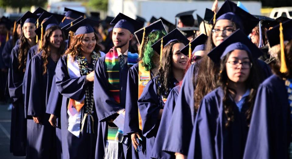 Merced College graduates make their way into Stadium ’76 for the school’s 60th commencement ceremony on Friday, May 26, 2023 in Merced, Calif.