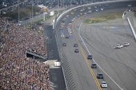 President Donald Trump's motorcade passes the grandstands as he leads the drivers around the track before the NASCAR Daytona 500 auto race at Daytona International Speedway, Sunday, Feb. 16, 2020, in Daytona Beach, Fla. (AP Photo/Phelan M. Ebenhack)