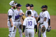Colorado Rockies starting pitcher Cal Quantrill, center, waits to hand the ball to manager Bud Black (10) during the eighth inning of a baseball game against the Pittsburgh Pirates in Pittsburgh, Friday, May 3, 2024. (AP Photo/Gene J. Puskar)