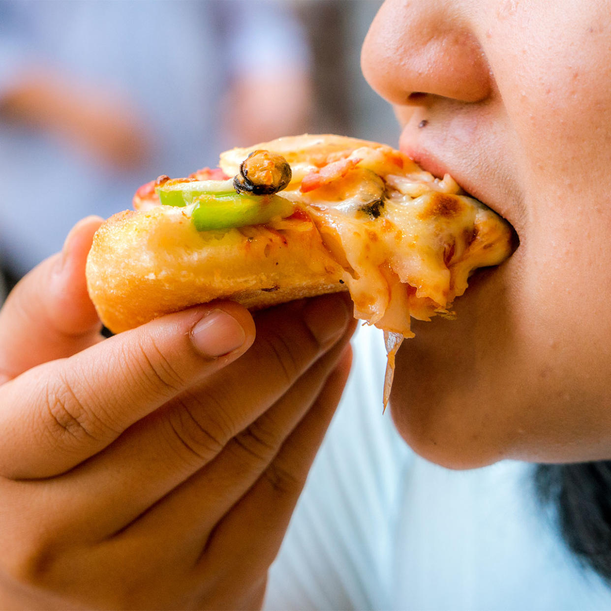 woman eating cheesy dinner