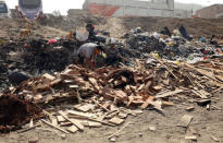 People search through garbage at the shanty town Nueva Esperanza on the outskirts of Lima, Peru March 28, 2018. Picture taken March 28, 2018. REUTERS/Mariana Bazo